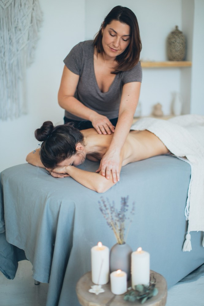 A massage therapist with a client
